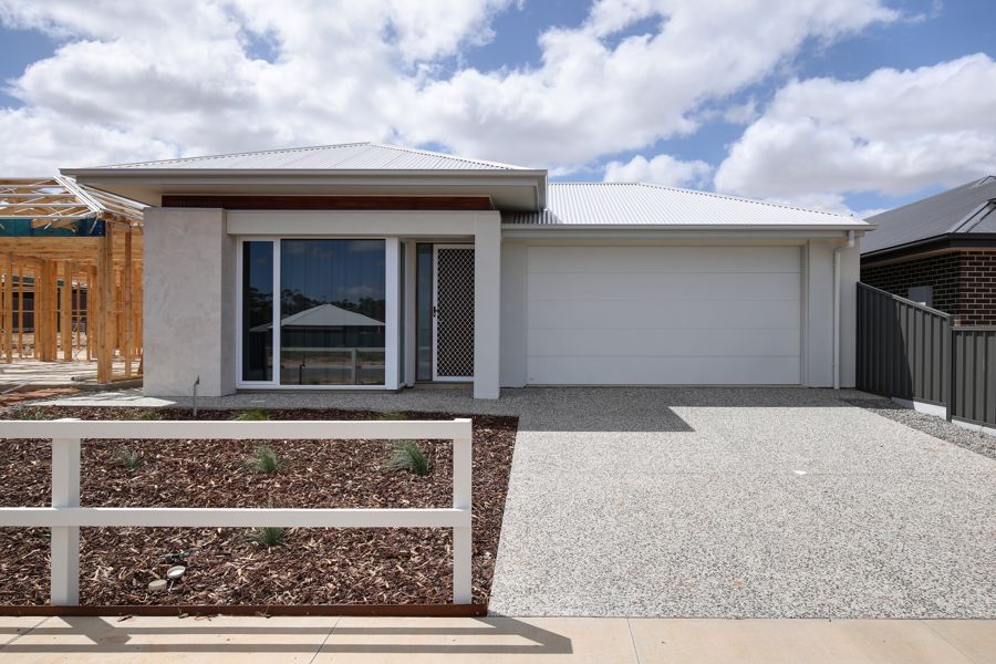 WELCOMING AND LIGHT FILLED, THIS SPACIOUS AND THOUGHTFULLY DESIGNED HOME IS SURE TO IMPRESS.