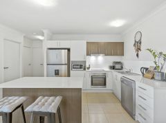 CLASSY NEAR NEW 2 BED 2 BATH UNIT DEDICATED 2 CAR SECURE GARAGING UNBEATABLE POSITION &NDASH; 100M TO NERANG TRAIN STATION